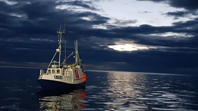 A single fishing boat alone on open water at twilight
